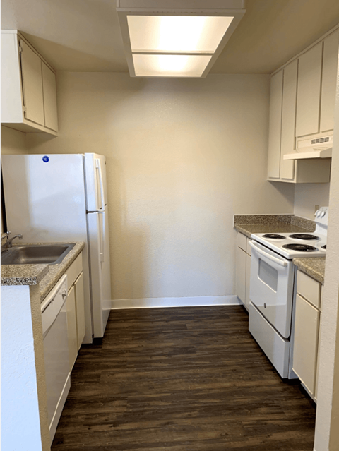 a kitchen with white appliances and white cabinets